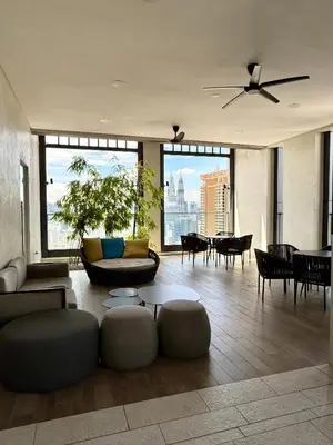 a living room with a ceiling fan and a couch at Lucentia residence bukit Bintang city centar in Kuala Lumpur