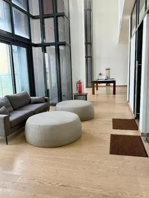 a living room with two ottomans and a couch at Lucentia residence bukit Bintang city centar in Kuala Lumpur