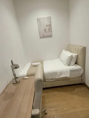 a room with a bed with a desk and a lamp at Lucentia residence bukit Bintang city centar in Kuala Lumpur