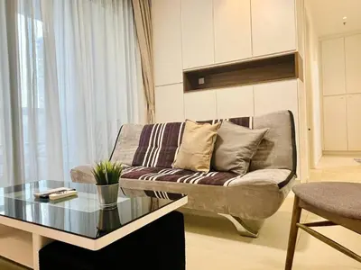 a living room with a couch and a glass table at 1-5 people, Scandinavian Style Arcoris Mont Kiara in Kuala Lumpur