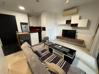 a living room with a couch and a table at 1-5 people, Scandinavian Style Arcoris Mont Kiara in Kuala Lumpur
