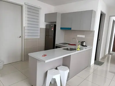 a white kitchen with a sink and two stools at Trion Hotel by HAVENZA near TRX, Time Square and Bukit Bintang in Kuala Lumpur