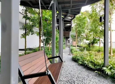 a swing hanging from a porch with plants at Trion Hotel by HAVENZA near TRX, Time Square and Bukit Bintang in Kuala Lumpur