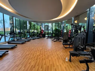 a gym with a row of treadmills and ellipticals at Trion Hotel by HAVENZA near TRX, Time Square and Bukit Bintang in Kuala Lumpur