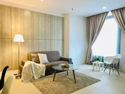 a living room with a couch and a table at Max 5pax, Muji Style Apartment Arcoris Mont Kiara in Kuala Lumpur