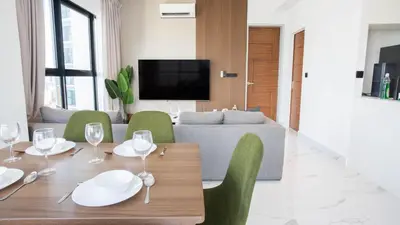 a living room with a table and chairs and a couch at Alfa Bangsar by Guestonic in Kuala Lumpur