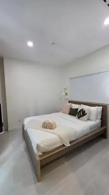 a large bed in a white room with pillows on it at Binjai 8 KLCC Premium Soho By Prime Suites in Kuala Lumpur
