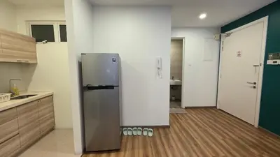 a kitchen with a refrigerator in the middle of a room at Binjai 8 KLCC Premium Soho By Prime Suites in Kuala Lumpur