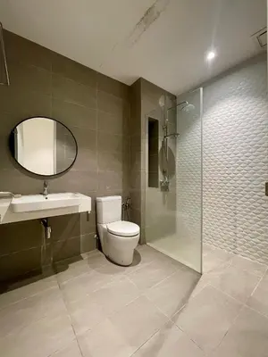 a bathroom with a toilet and a sink and a shower at Quill Residences KLCC By ONZO in Kuala Lumpur