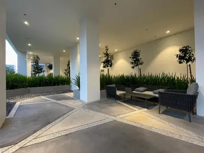 a patio with two chairs and a couch and plants at Quill Residences KLCC By ONZO in Kuala Lumpur