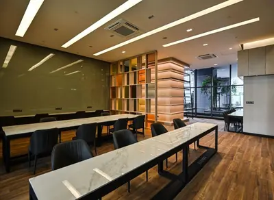 a meeting room with tables and chairs in a building at Star Residence Heart of KLCC in Kuala Lumpur