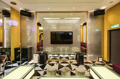 a lobby with a television and chairs in a building at Star Residence Heart of KLCC in Kuala Lumpur