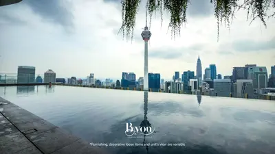 a view of the city from the rooftop pool of a skyscraper at Ceylonz Premium Suites KLCC by BYON in Kuala Lumpur
