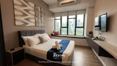a bedroom with a bed and a television in it at Ceylonz Premium Suites KLCC by BYON in Kuala Lumpur