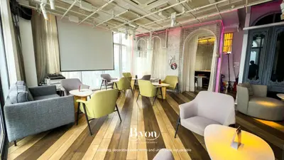 a waiting room with chairs and tables and a whiteboard at Ceylonz Premium Suites KLCC by BYON in Kuala Lumpur