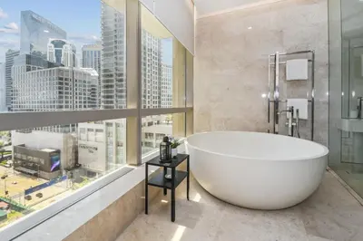 a bathroom with a large tub and a large window at Bodhi Banyan Pavilion Kuala Lumpur by WSD in Kuala Lumpur