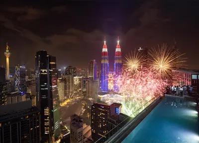 a night view of a city skyline with fireworks at Imperial KLCC by WSD in Kuala Lumpur