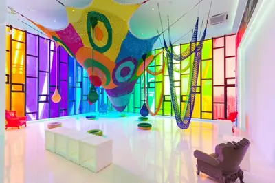 a room with a colorful wall of glass at Arte Mont Kiara by CozyVista Suites in Kuala Lumpur