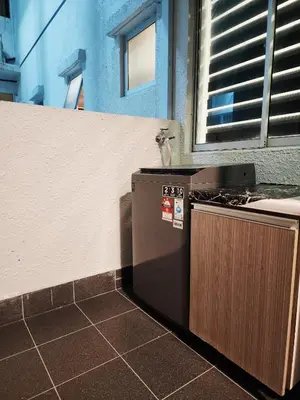 a stove in a kitchen next to a wall at RC Residence 6 pax by Define Suite in Kuala Lumpur