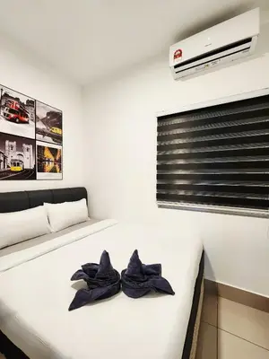 a bedroom with a white bed with blue towels on it at RC Residence 6 pax by Define Suite in Kuala Lumpur