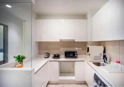 a white kitchen with a sink and a microwave at Astoria Ampang Modern 2Bedroom Suite Free Parking in Kuala Lumpur