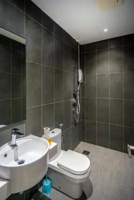 a bathroom with a white toilet and a sink at Astoria Ampang Modern 2Bedroom Suite Free Parking in Kuala Lumpur