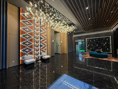 a lobby with a wall of wine bottles at Royale Suites At Majestic Residence KL in Kuala Lumpur
