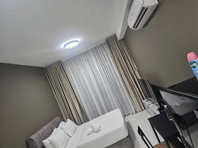 a hotel room with a bed and a window at Royale Suites At Majestic Residence KL in Kuala Lumpur
