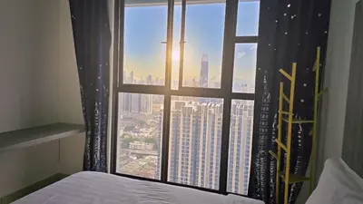 a bedroom with a window with a view of a city at Trion KL Star Suites in Kuala Lumpur