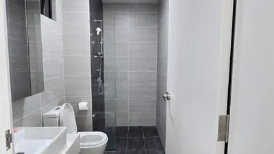 a bathroom with a shower and a toilet and a sink at Trion KL Star Suites in Kuala Lumpur