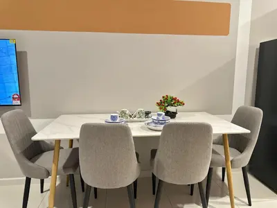 a dining room table with chairs and a white table at Luxury couple suite 307A at Majestic Residence in Kuala Lumpur