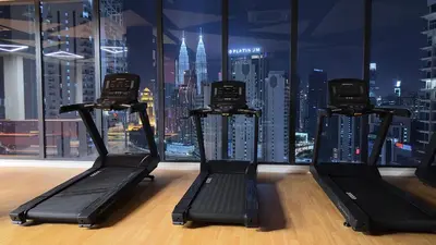 a gym with a view of a city skyline at Private family suite 1113A1BR at Majestic Residence in Kuala Lumpur