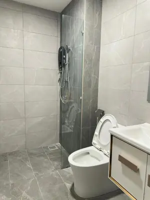 a bathroom with a shower and a toilet and a sink at Private family suite 1113A1BR at Majestic Residence in Kuala Lumpur