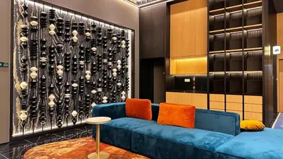 a blue couch with orange pillows in a room at Private family suite 1113A1BR at Majestic Residence in Kuala Lumpur