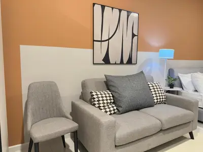 a living room with a couch and two chairs at Luxury suite for couple 267A at KLCC in Kuala Lumpur
