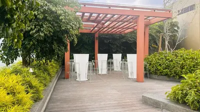 a pavilion with tables and chairs in a garden at Luxury suite 293A at KLCC in Kuala Lumpur