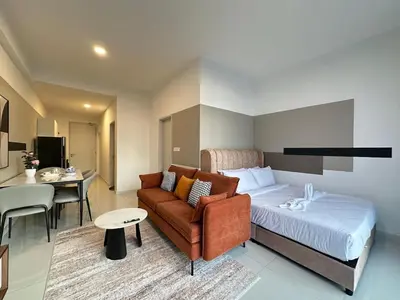 a bedroom with a bed and a couch and a table at Private family apartment 27131BR at Majestic Residence in Kuala Lumpur