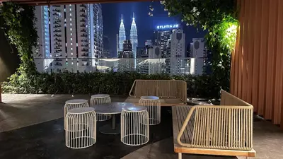 a table and chairs with a view of a city at Luxury couple suite 23A3A at Majestic Residence in Kuala Lumpur