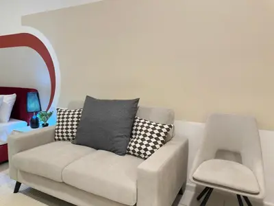 a living room with a couch and a chair at Luxury couple suite 251B at KLCC in Kuala Lumpur