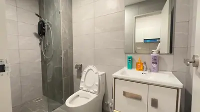 a bathroom with a shower and a toilet and a sink at Luxury couple suite 251B at KLCC in Kuala Lumpur