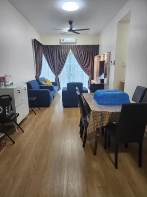 a living room with a table and a blue couch at RC Balqis Homestay in Kuala Lumpur