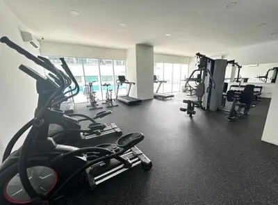 a gym with several treadmills and machines in it at RC Balqis Homestay in Kuala Lumpur