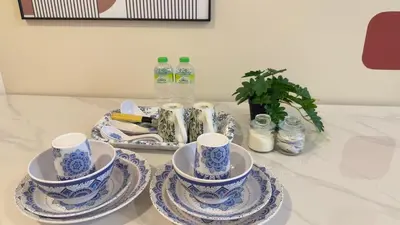 a table with blue and white cups and saucers at Cozy suite for couples 291B at KLCC in Kuala Lumpur