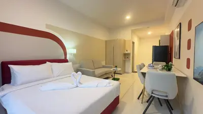 a hotel room with a bed and a table and chairs at Cozy suite for couples 291B at KLCC in Kuala Lumpur