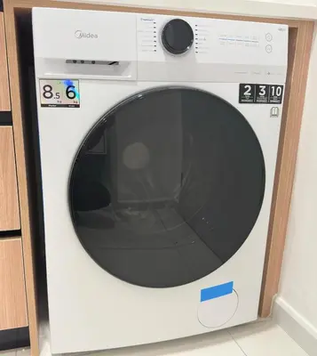 a white washing machine with a black window at Cozy Couple studio 307B at KLCC in Kuala Lumpur