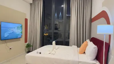 a hotel room with a bed and a window at Cozy Couple studio 307B at KLCC in Kuala Lumpur