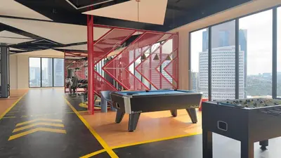 a room with a pool table in a building with windows at Cozy couple suite 272A at KLCC in Kuala Lumpur