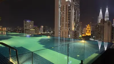 a view of a city skyline at night at KLCC view couple suite 277B at KLCC in Kuala Lumpur