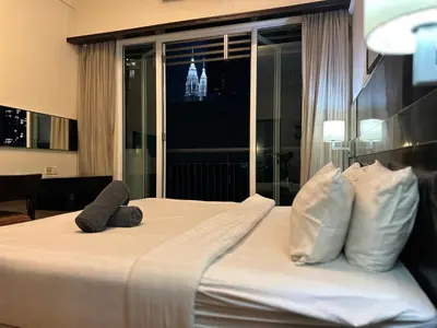 a hotel room with a bed with two stuffed animals on it at Seri Bukit Ceylon Bukit Bintang Kuala Lumpur City Centre in Kuala Lumpur