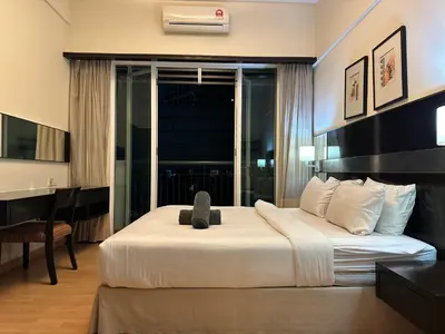 a bedroom with a large bed with a large window at Seri Bukit Ceylon Bukit Bintang Kuala Lumpur City Centre in Kuala Lumpur